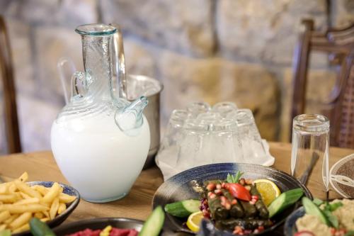 a table with a plate of food and a bottle of milk at Chateau Du Comte 