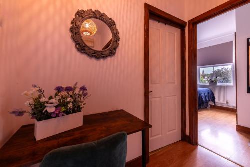 a hallway with a table with a vase of flowers at Southampton City Centre Apartment Free Private Parking in Southampton