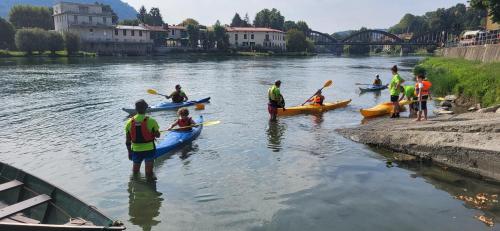 a group of people in kayaks on a river at Appartamento nel cuore di Brivio in Brivio