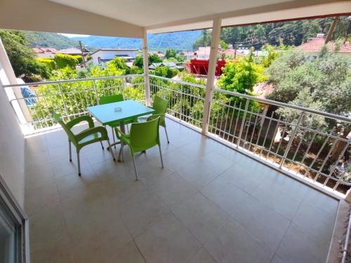 a balcony with a table and chairs on it at Bucak Apart Hotel Göcek & Beach in Göcek