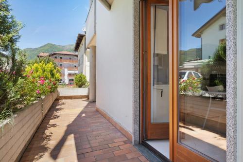 a glass door to a balcony with a view at Appartamento Cuore di Comano in Comano Terme
