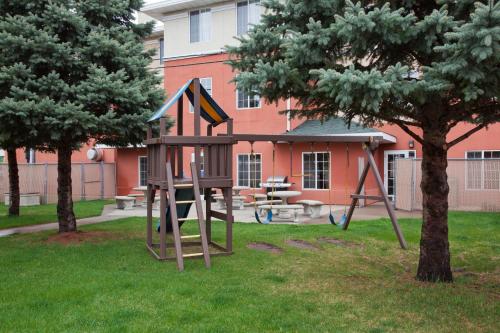a playground in the yard of a building at GrandStay Residential Suites Hotel in Saint Cloud