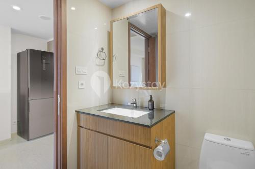 a bathroom with a sink and a mirror at Sivora by Kozystay - Kuningan in Jakarta