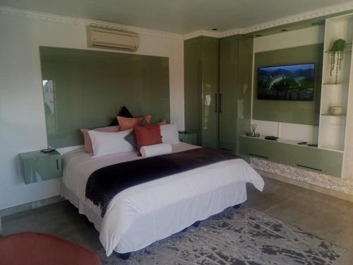 a bedroom with a large bed in a room at Lesiba guesthouse in Kwamhlanga