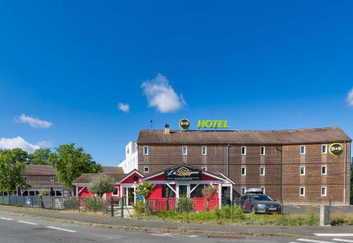 a hotel building with a sign on top of it at B&B HOTEL Orleans Saint-Jean de Braye in Saint-Jean-de-Braye
