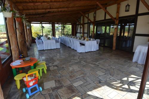a group of tables and chairs in a room at Hotel Stawisko Klaudyn in Klaudyn