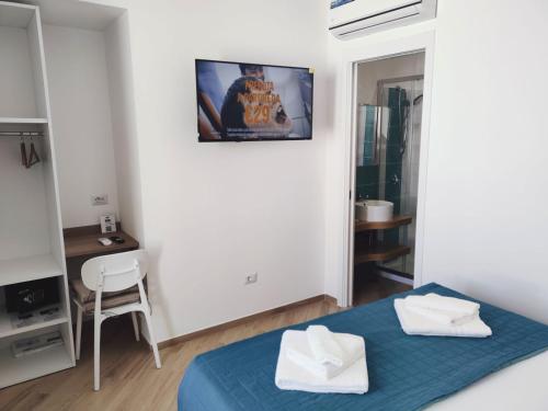 a bedroom with a bed and a tv on the wall at La Parata in Ponza