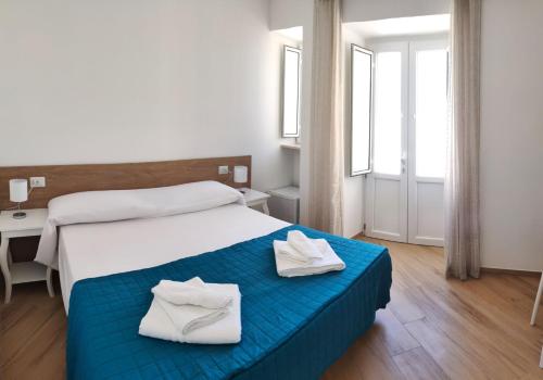 a bedroom with a bed with two white towels on it at La Parata in Ponza