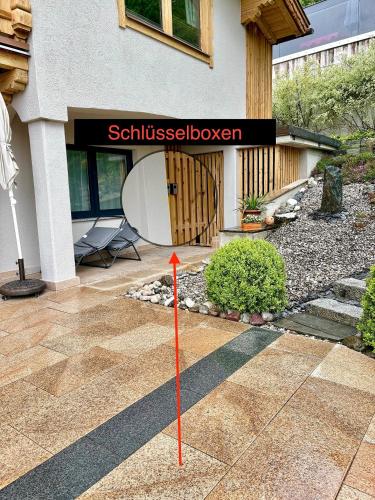 a house with a sign that reads schulessholmholm at Apartment MarLen in Eben am Achensee