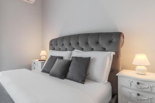 a bedroom with a large bed with white sheets and pillows at FELIX LOTUS - DeLuxe Residence in Baile Felix