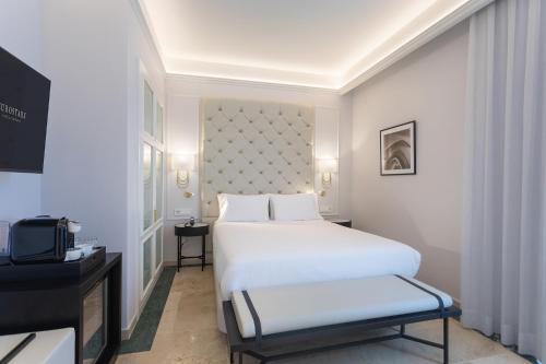 a hotel room with a bed and a tv at Eurostars Laietana in Barcelona