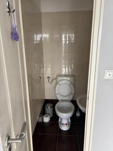 a small bathroom with a toilet and a sink at Centrum Vendégház in Debrecen