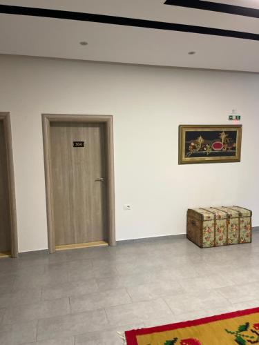 a room with a door and a picture on the wall at Kutal Park Inn Hotel in Përmet