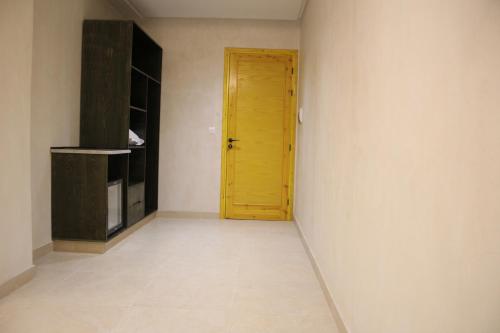 a hallway with a yellow door in a room at Hôtel Medina in Sousse
