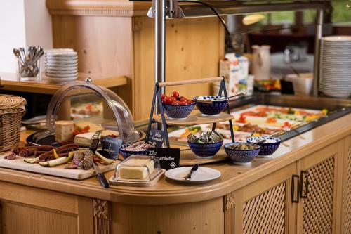 a table with food on a counter in a kitchen at Hotel Langeck in Maria Alm am Steinernen Meer