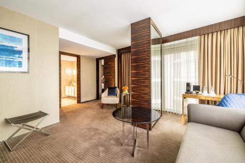 a living room with a couch and a table at Grand Ankara Hotel Convention Center in Ankara