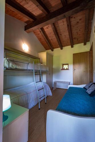 Postel nebo postele na pokoji v ubytování Albergo Diffuso Forgaria Monte Prat