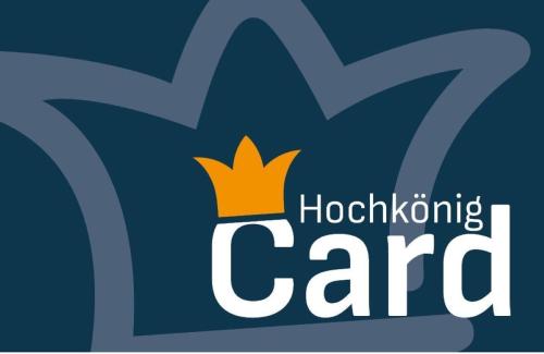 a logo for a hospital caring center with a crown at Hotel Langeck in Maria Alm am Steinernen Meer