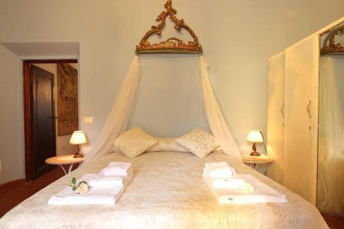 a bedroom with a bed with a canopy at I Giardini di Marcello - Villa 1 in Dicomano