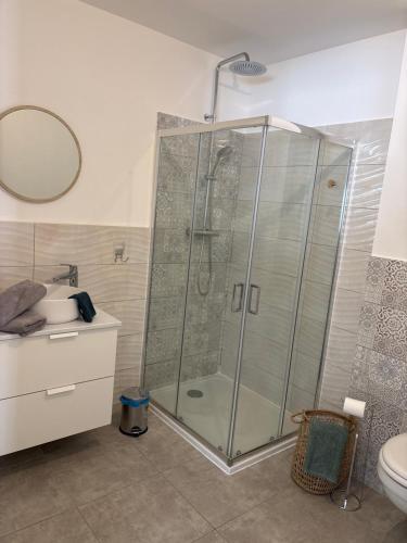 a bathroom with a shower with a sink and a toilet at Les jardins de Saint Pancrace in Corte