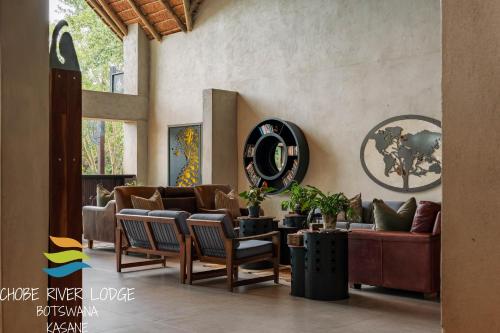 a living room with a couch and chairs at Chobe River Lodge in Kasane