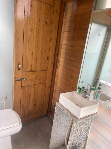 a bathroom with a sink and a toilet and a mirror at Okho Resort Kalka Panchkula in Kālka
