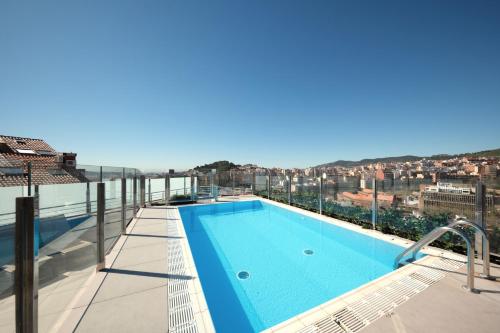a swimming pool on the roof of a building at Catalonia Park Güell in Barcelona