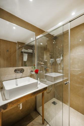 a bathroom with a sink and a shower at Quality Inn Elite Levelup Boutique in Amritsar