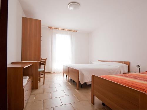 Postel nebo postele na pokoji v ubytování Albergo Alpino da Tullio
