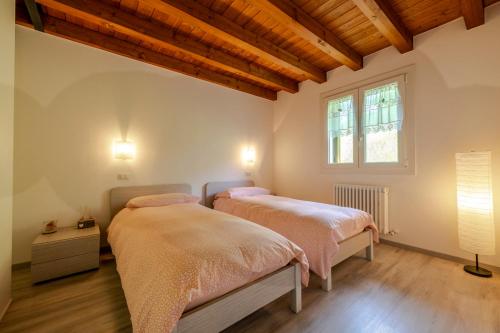 Postel nebo postele na pokoji v ubytování Albergo Diffuso Forgaria Monte Prat