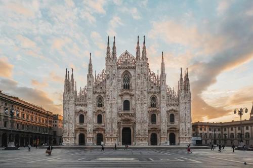 a large cathedral building with a cloudy sky at Monza-Milan - In the Center, 5' Station - Wifi - A-C in Monza