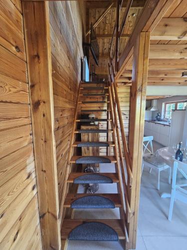 a staircase in a house with wooden walls at chalet saint Hubert in Saint-Hubert