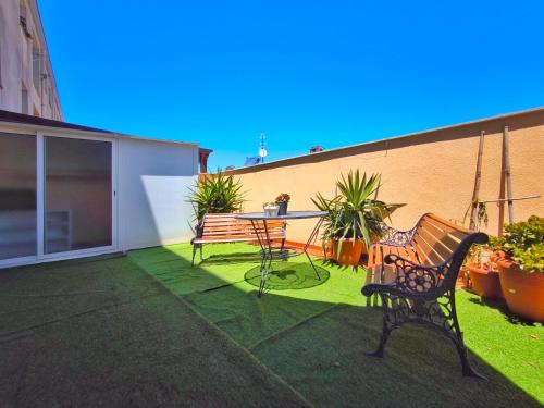 a patio with a table and chairs on a lawn at Amplio y Cómodo Apartamento con Terraza, Ulldecona in Ulldecona