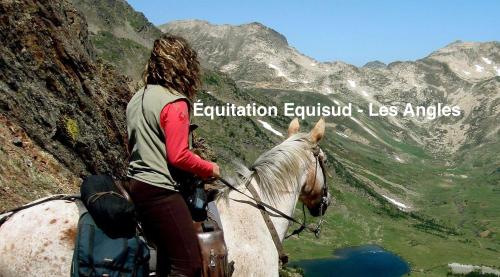 a woman riding a horse in the mountains at Chalet Vue sous cet Angles in Les Angles