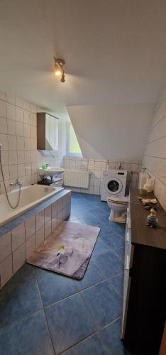 a large kitchen with a sink and a tub and a sink at Ferienwohnung Erzhütte in Rechenberg-Bienenmühle