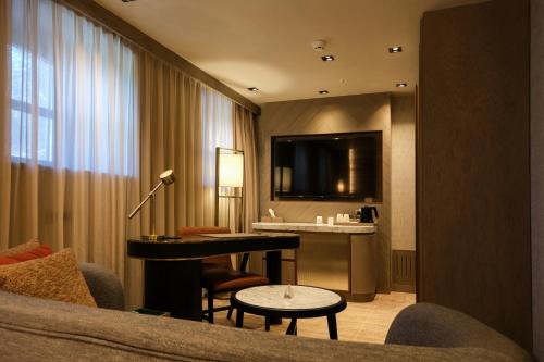 a hotel room with a piano and a desk at Swissotel Uludag Bursa in Bursa