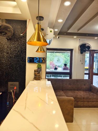 a living room with a couch and a table at Hotel Shadow Regency in Ernakulam
