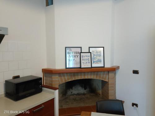 a room with a fireplace with pictures and a tv at wagner 11 in Faenza