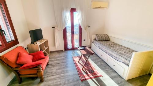 a living room with a couch and a chair at Kalliope Studios Karpathos in Amoopi
