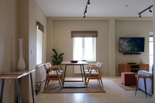 a dining room with a table and chairs in a room at Villa 1868 in Mithymna