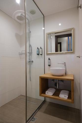a bathroom with a sink and a glass shower at Villa 1868 in Mithymna