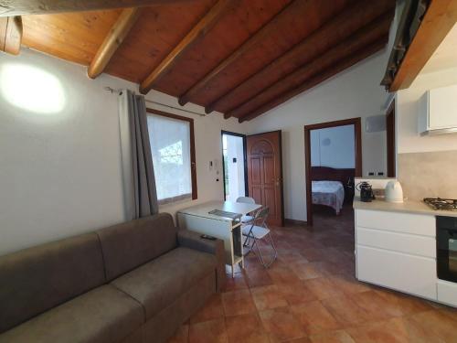 a living room with a couch and a kitchen at Guido Holiday Home - Torre di Barì in Bari Sardo