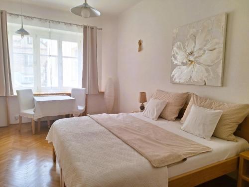 a bedroom with a bed and a table and a window at St. Hubert House in Prague