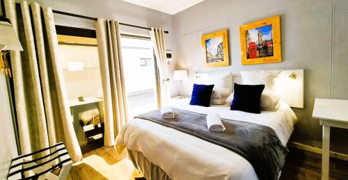 a bedroom with a large bed and a window at Tiende Laan Bed & Breakfast and Self-Catering in Walvis Bay