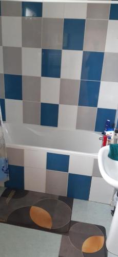 a bathroom with a toilet in front of a tub at Maison rue Sonia Delaunay LE MANS in Le Mans
