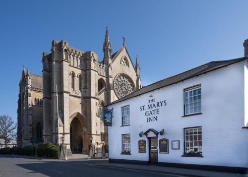 a white building in front of a church at St Marys Gate Inn in Arundel