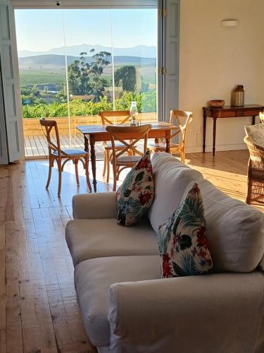 a living room with a couch and a table at Klaasvoogds Loft in Robertson