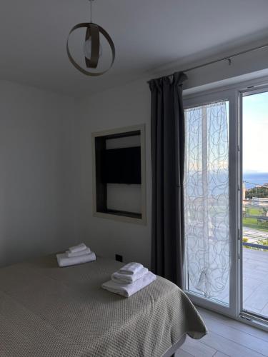 a bedroom with a bed and a large window at Tenuta Croce in Salerno