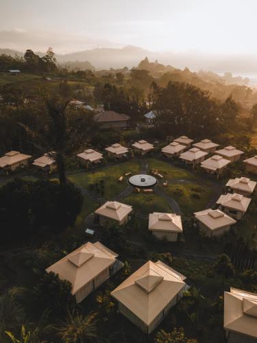 an aerial view of a resort compound with tents at Toteme Glamping and Hot Spring Kintamani in Kintamani