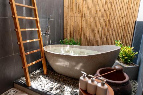 a bath tub with a ladder in a bathroom at Le Palmier Long An Boutique Resort - Free Outdoor Cinema in Ấp Kế Mỹ